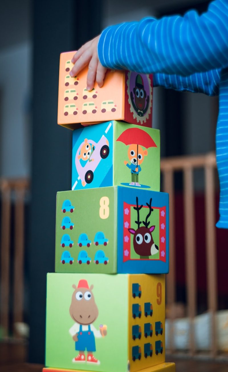 child building an four boxes